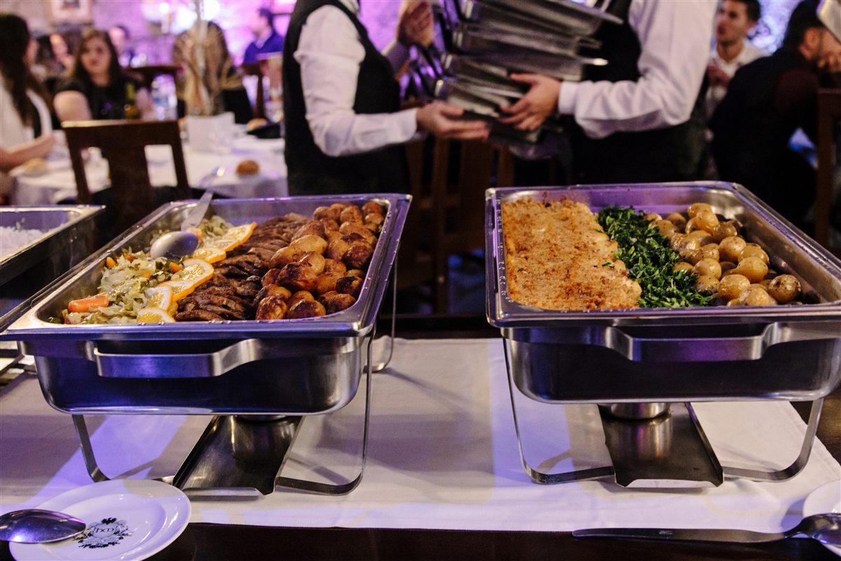 Staff serving a buffet at an evening event